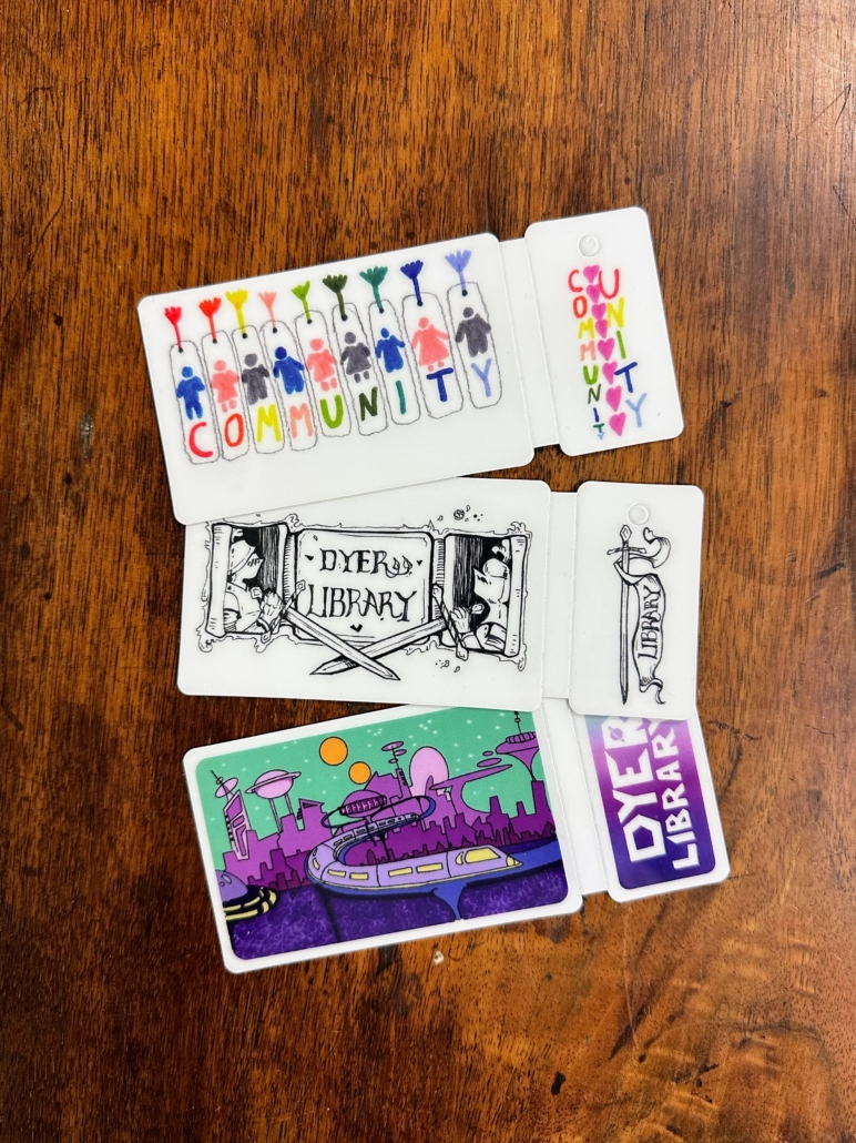 three library cards with artwork