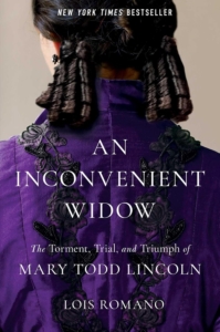 a woman in a purple dress and black ring curls shown from the back